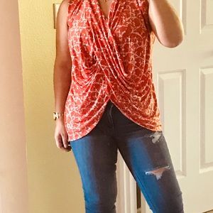 Sleeveless cross front draped blouse.